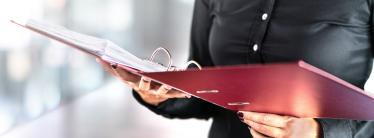 woman with red file and paper