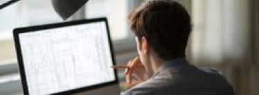 man working on a computer at home