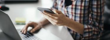 Person Working with Laptop and Mobile Phone