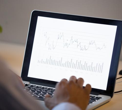 small business owner uses laptop to report on business analytics