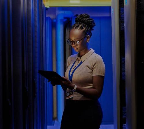 image showing business woman holding laptop in dark room